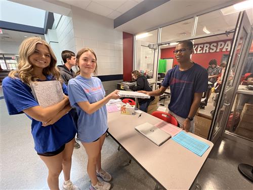 students picking up yearbooks at Bob Jones High School